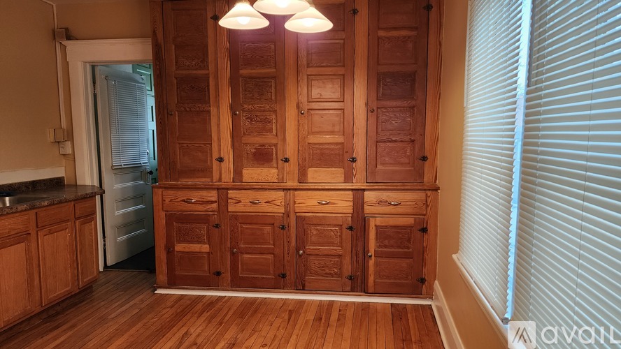 A kitchen with wooden cabinets and a refrigerator.