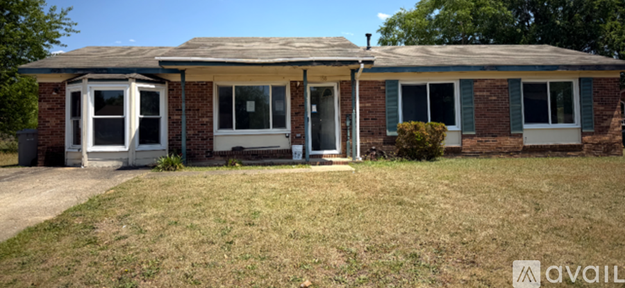 A house with a white door and windows is for sale.