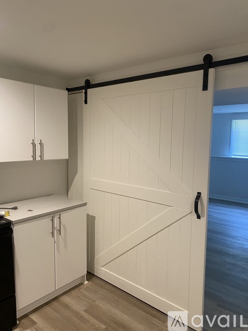 A white barn door in a kitchen.