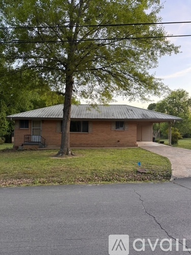 A house with a tree in front of it.