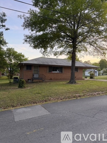 A house with a tree in front of it.
