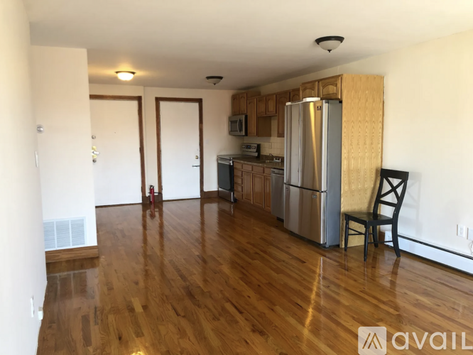 A kitchen with a refrigerator, microwave, and oven.