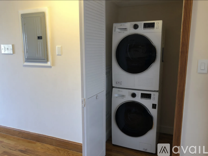 Two white front loading washing machines in a laundry room.