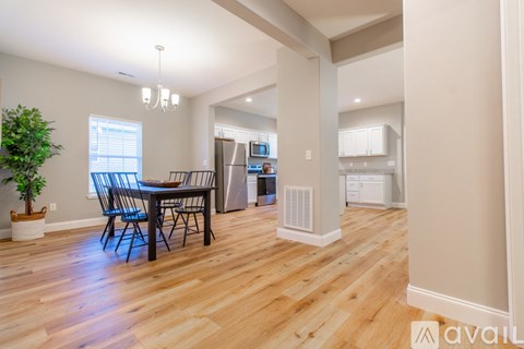 A dining room with a table and chairs is shown.