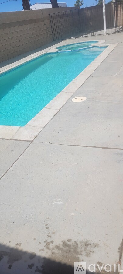 A pool with a blue water and a white line around it.