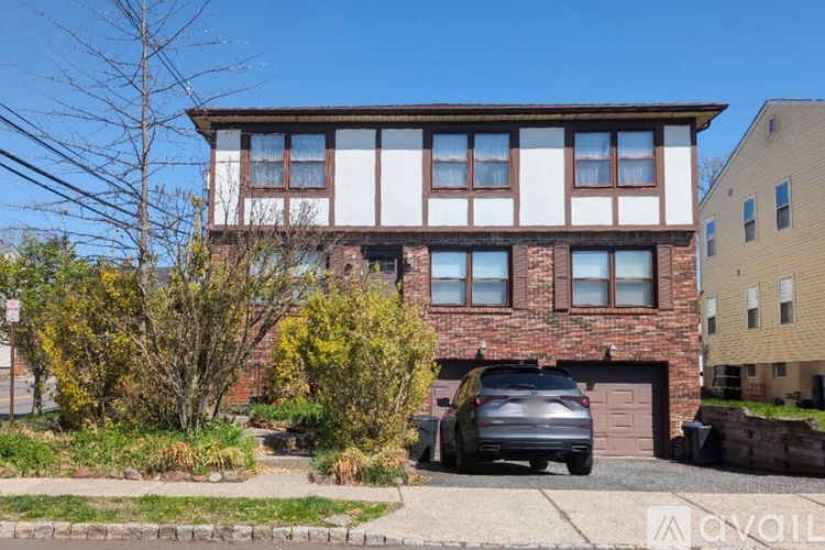 A house with a car parked in front of it.