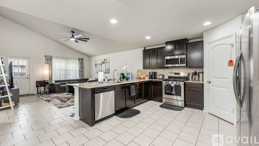 A modern kitchen with a large island and stainless steel appliances.