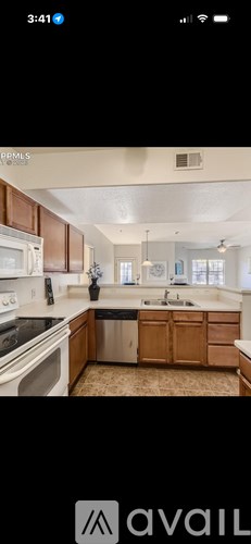 A kitchen with wooden cabinets and a white stove top oven.