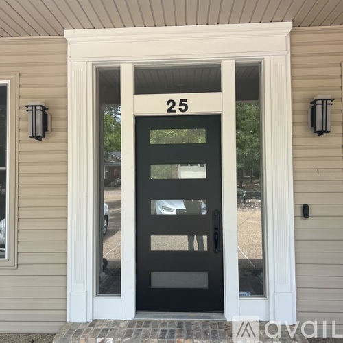 A black door with a glass window and a number 25 above it.