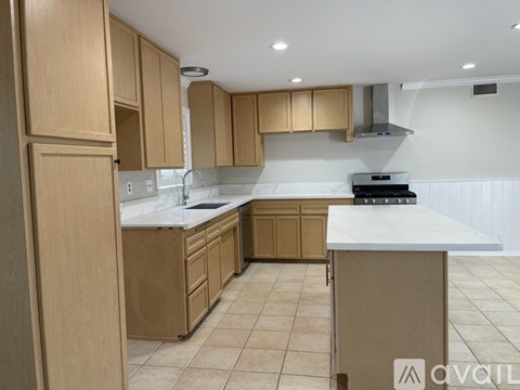 A kitchen with wooden cabinets and a white countertop.