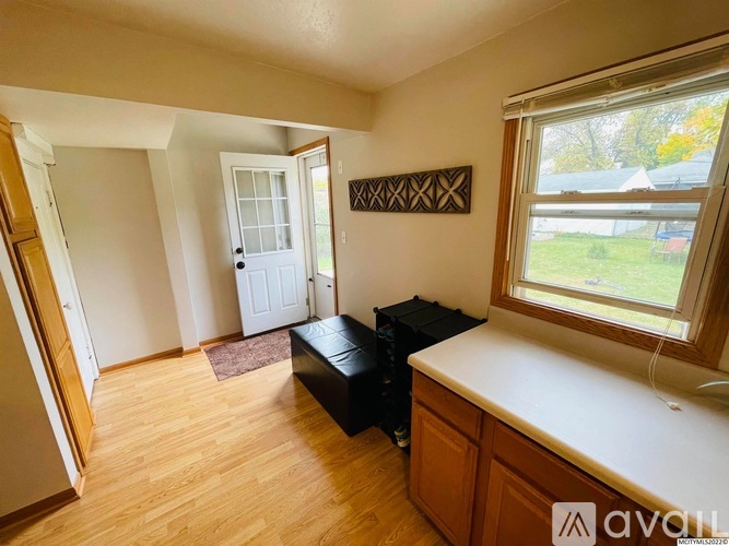 A room with wooden floors and a white door.