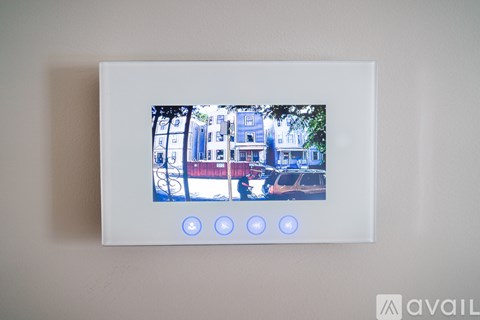 A white framed picture with a blue and white building and three blue lights on the bottom.