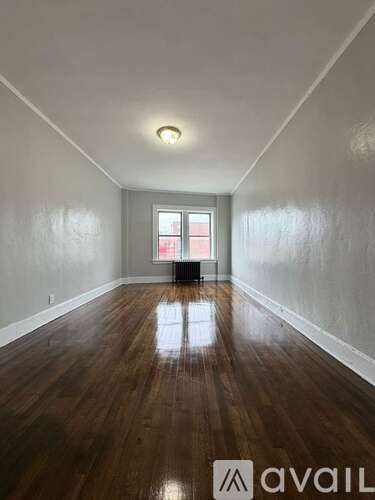 A room with wooden floors and a window.