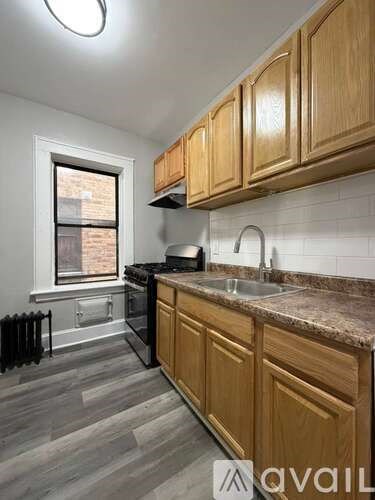 A kitchen with wooden cabinets and a granite countertop.