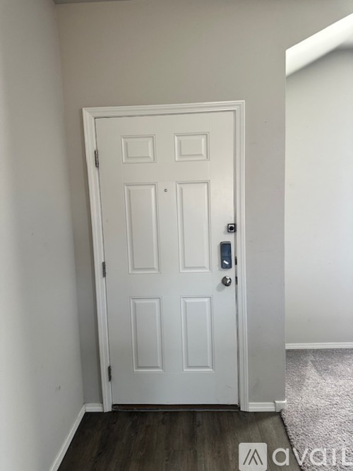 A white door with a black handle and lock.