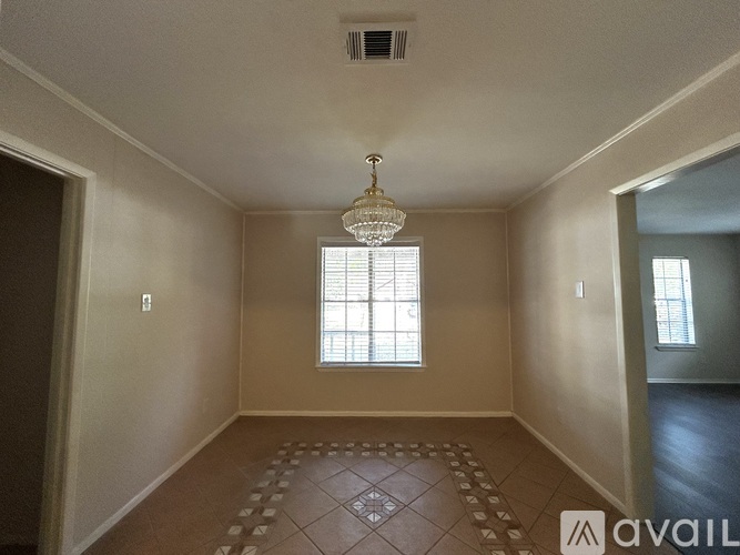 A room with a tiled floor and a chandelier hanging from the ceiling.