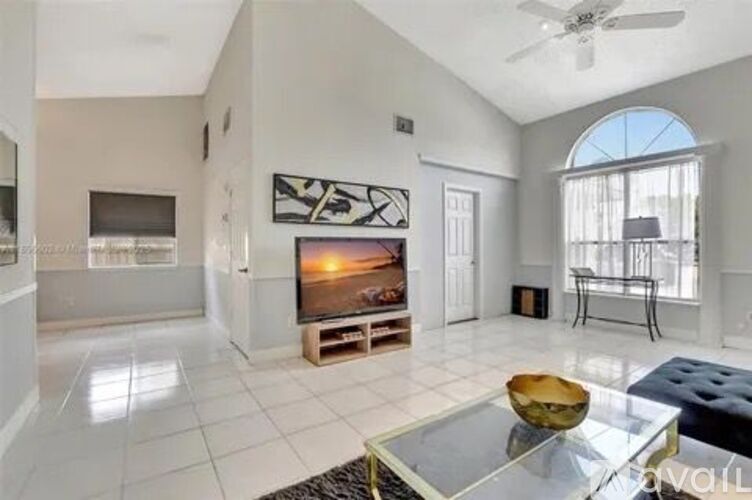 A living room with a fireplace and a television on a stand.