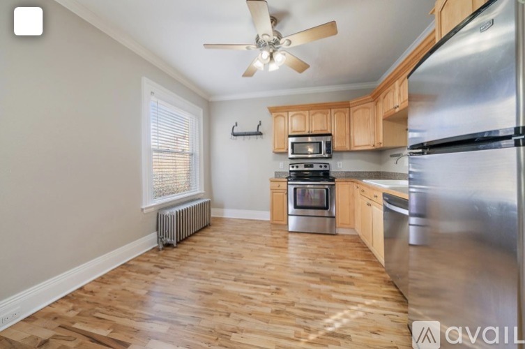 A kitchen with wooden floors and stainless steel appliances.