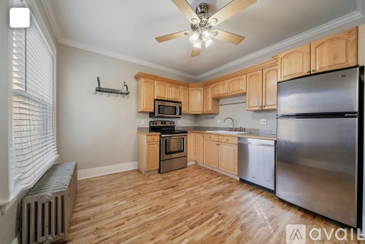 A kitchen with wooden cabinets and stainless steel appliances.