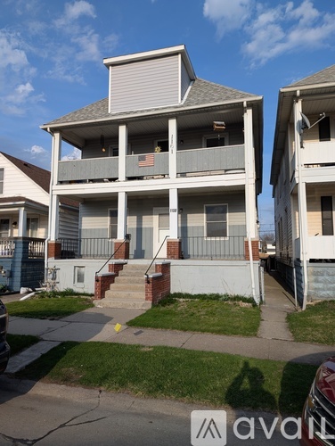 A two-story apartment building with a balcony on the second floor.