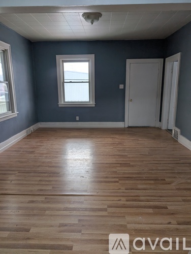 A room with wooden floors and a window.