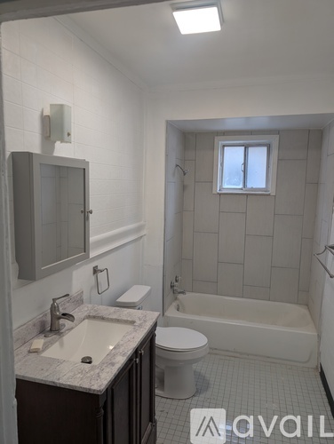 A bathroom with a sink, toilet, and bathtub.
