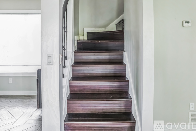 A staircase with a white railing and wooden steps.