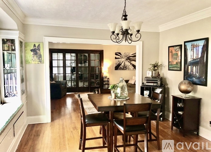 A dining room with a wooden table and chairs.