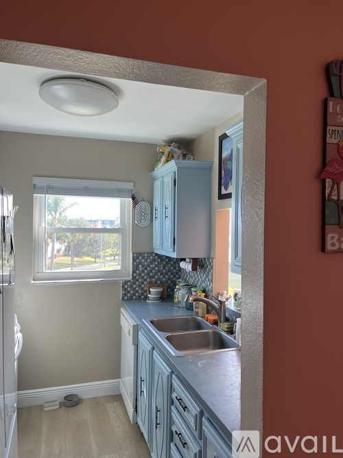 A kitchen with a sink and cabinets.