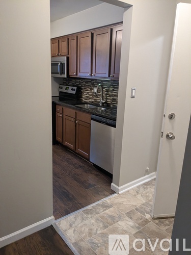 A kitchen with wooden cabinets and a tiled backsplash.