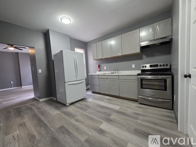 A kitchen with a stove, oven, and cabinets.