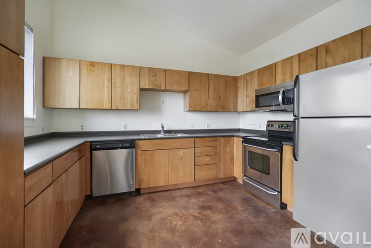 A kitchen with wooden cabinets and a white refrigerator.