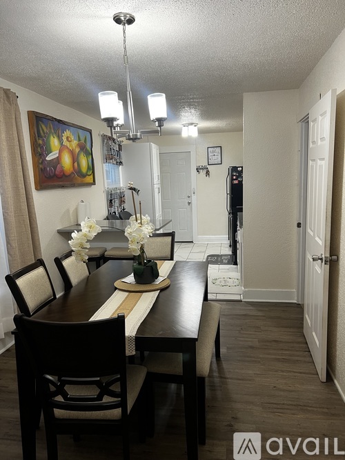 A dining room with a wooden table and chairs.