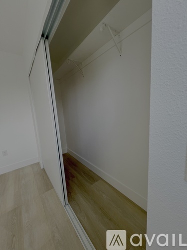 A room with a sliding door and wooden flooring.