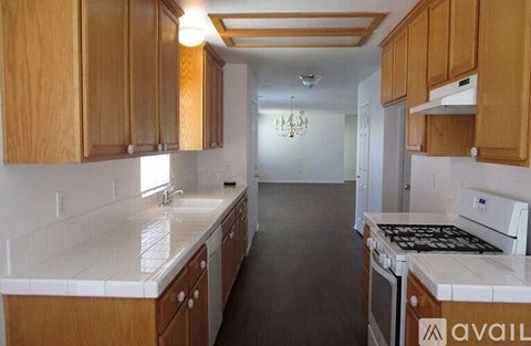 A kitchen with wooden cabinets and a white countertop.