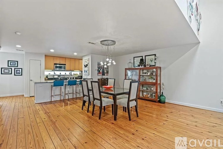 A kitchen with a dining table and chairs.