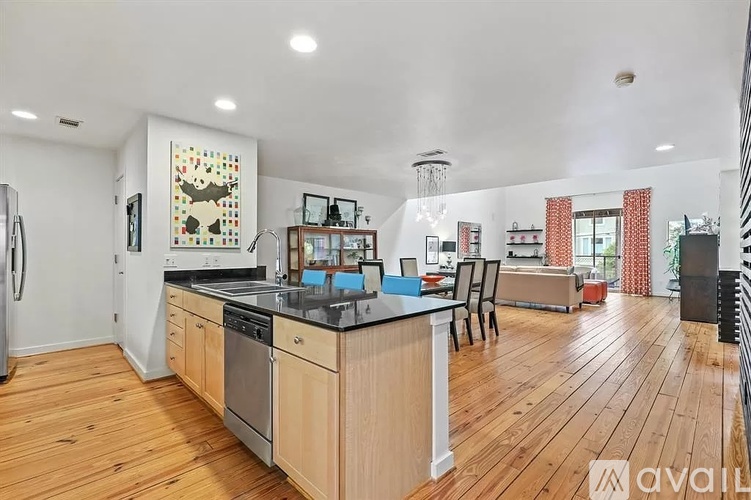 A kitchen with wooden floors and a large island in the middle.