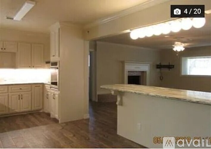 A kitchen with white cabinets and a countertop.
