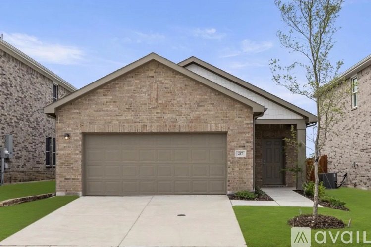 A house with a garage door that is open.