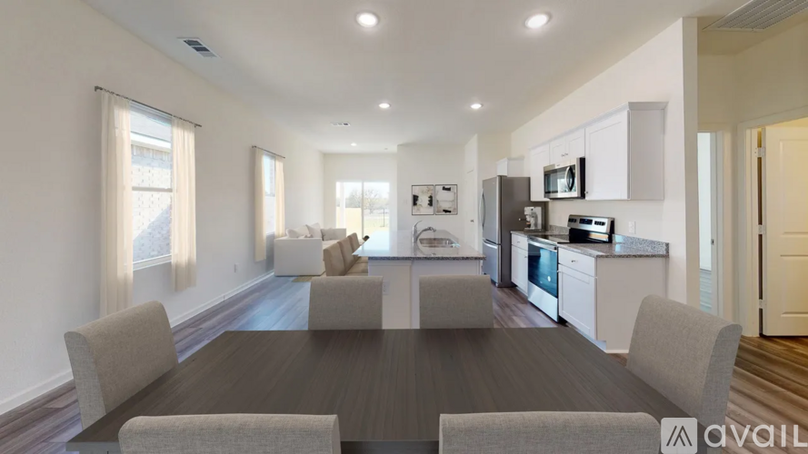 A modern kitchen with a dining table and chairs is available for rent.