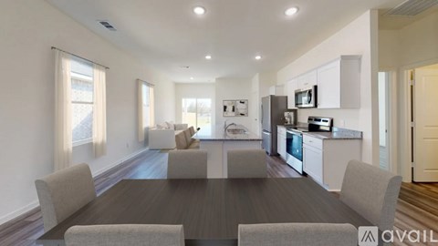 A modern kitchen with a dining table and chairs is available for rent.