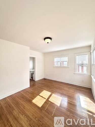 A room with wooden flooring and a window.