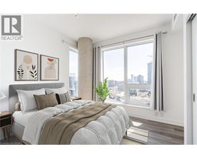 A bedroom with a large bed and a view of the city.
