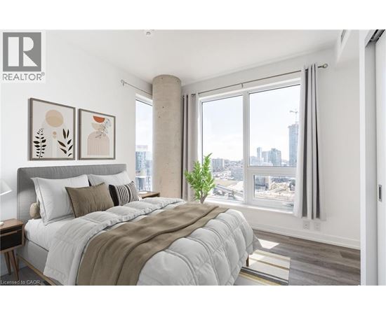 A bedroom with a large bed and a view of the city.