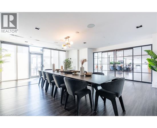 A modern dining room with a long table and chairs.