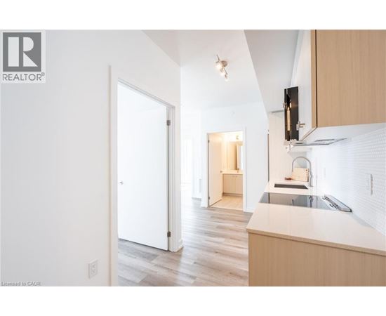 A kitchen with a sink and a refrigerator.