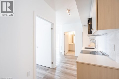A kitchen with a sink and a refrigerator.