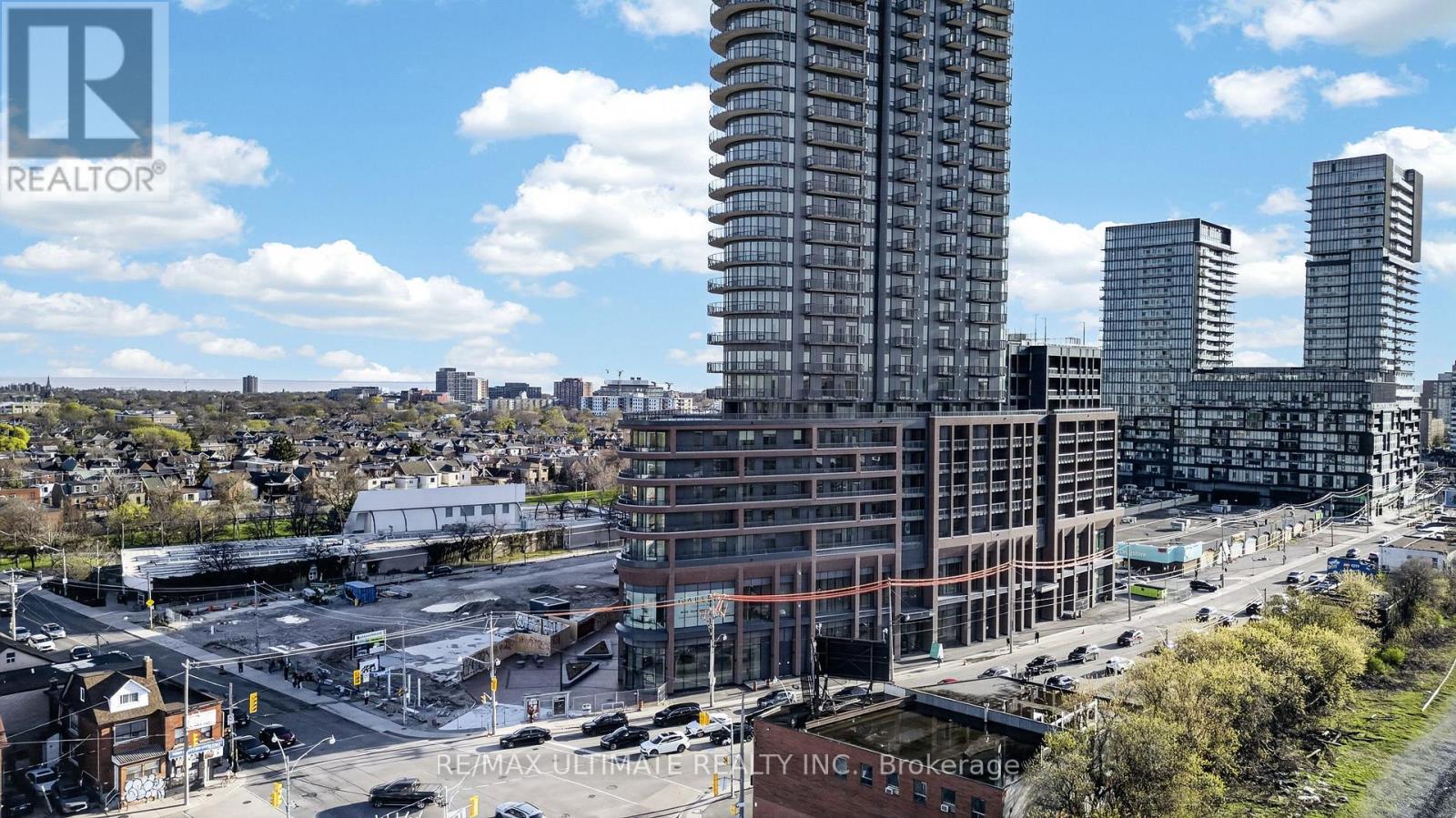 A cityscape with a large building under construction in the foreground.