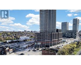 A cityscape with a large building under construction in the foreground.