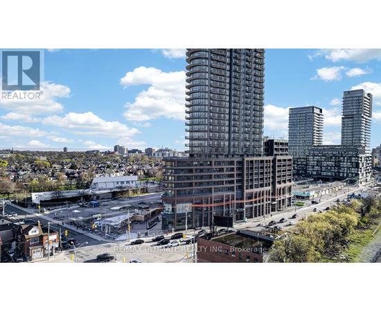 A cityscape with a large building under construction in the foreground.
